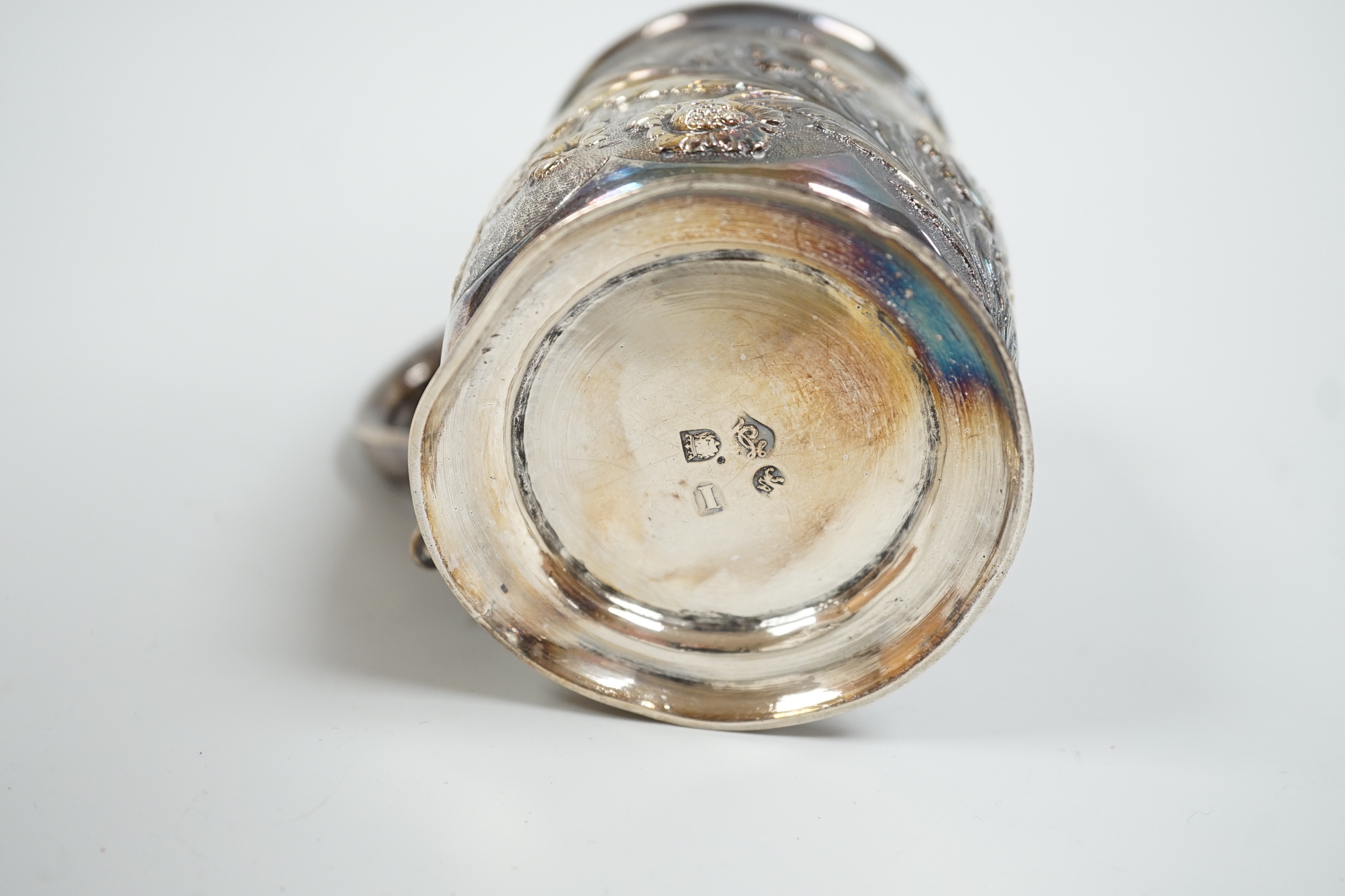 A George II silver mug, with later embossed decoration, makers mark rubbed, London, 1724, 9cm, (a.f.) 6.1oz.